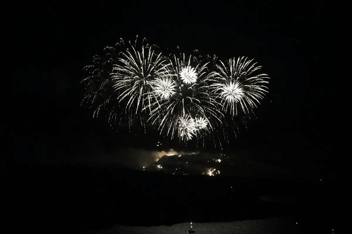 White fireworks above the volcano at night