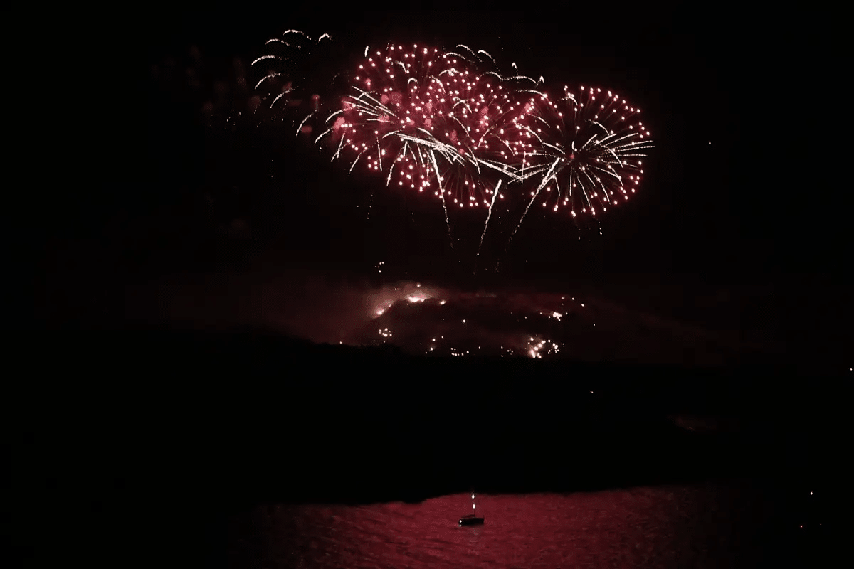 Red and gold fireworks over Santorini volcano at Ifestia 2026